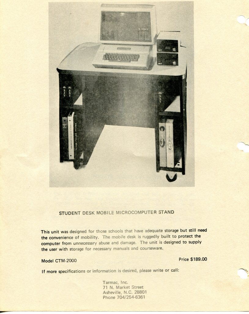 Document scan about a Student Desk Mobile Microcomputer Stand. A black and white photo shows a small wheeled desk holding a vintage computer with monitor and keyboard, plus two external drives. Side shelves store binders and manuals. Caption reads STUDENT DESK MOBILE MICROCOMPUTER STAND. Text explains the rugged, mobile design for schools, offering protection and storage. Model CTM-2000. Price 189.00. Footer provides contact for Tarmac, Inc., 71 N. Market Street, Asheville, N.C. 28801, phone 704 254 6361. The page has punched holes along the right edge.